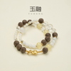 Crystal bracelet for sleep with amethyst beads and lavender herbs placed on bedside table with soft lighting