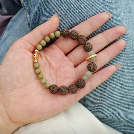 anxiety relief bracelet on wrist with CALM GROUND RESET badge