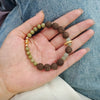 anxiety relief bracelet on wrist with CALM GROUND RESET badge