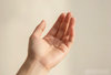 Little finger palmistry: a hand shown in soft natural light, used as featured image for Laxne Wellness Journal article on Chinese folk observation