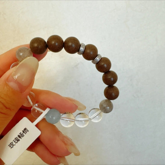 Lily & Magnolia Serenity Bracelet by Laxne Kongyulan on wooden table