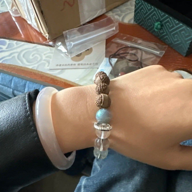 Artisan crafting Lily & Magnolia Serenity Bracelet with herbal beads