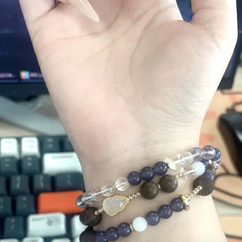 Lily & Magnolia Serenity Bracelet on wrist, showcasing handcrafted herbal beads and crystal for wellness.