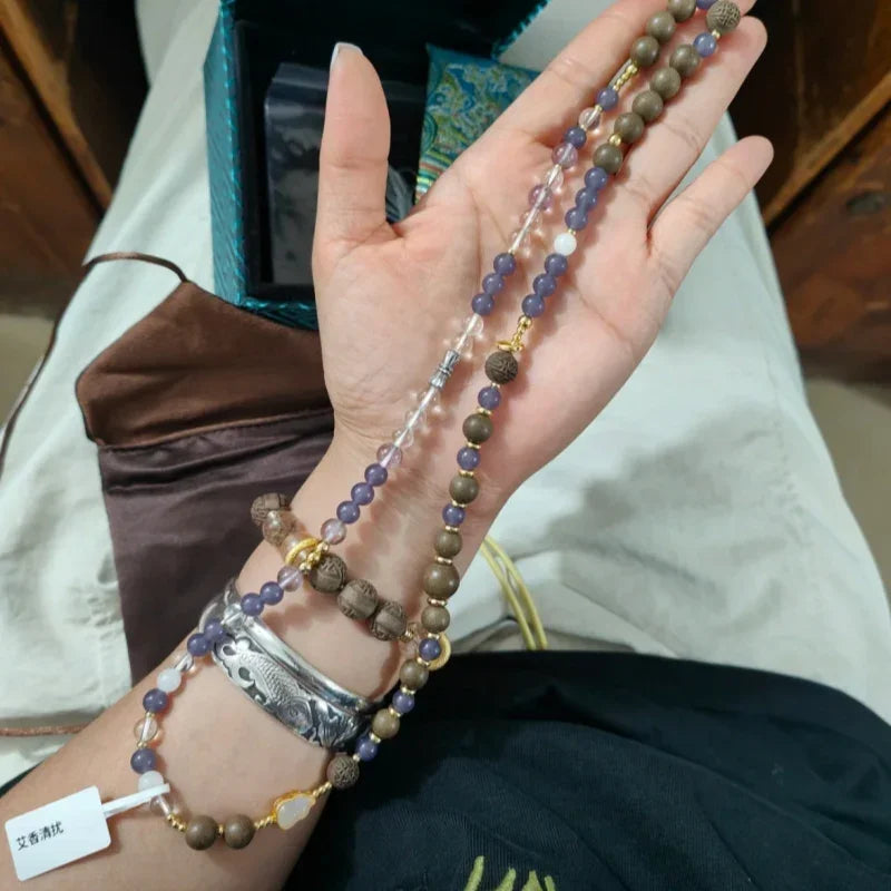 Elegant woman wearing the Ziyanfu Aixiangqingrao Energy Bracelet, symbolizing wellness and grace